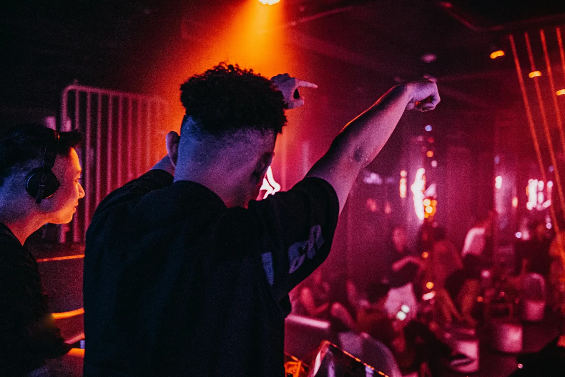 Private Parties - dj raising arms in a nightclub
