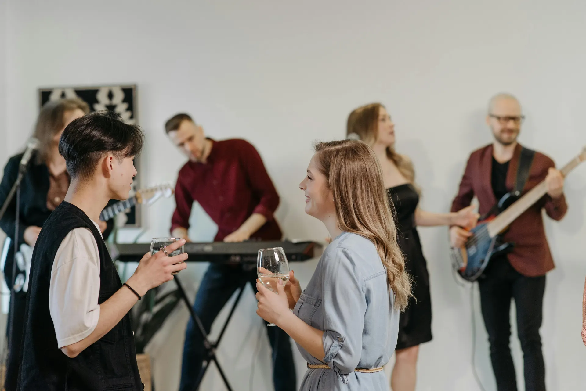Private Parties - man and woman talking while at the party with band playing